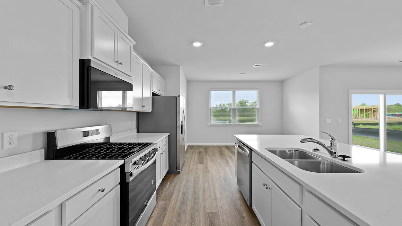 Kitchen with white cabinets and quartz countertops