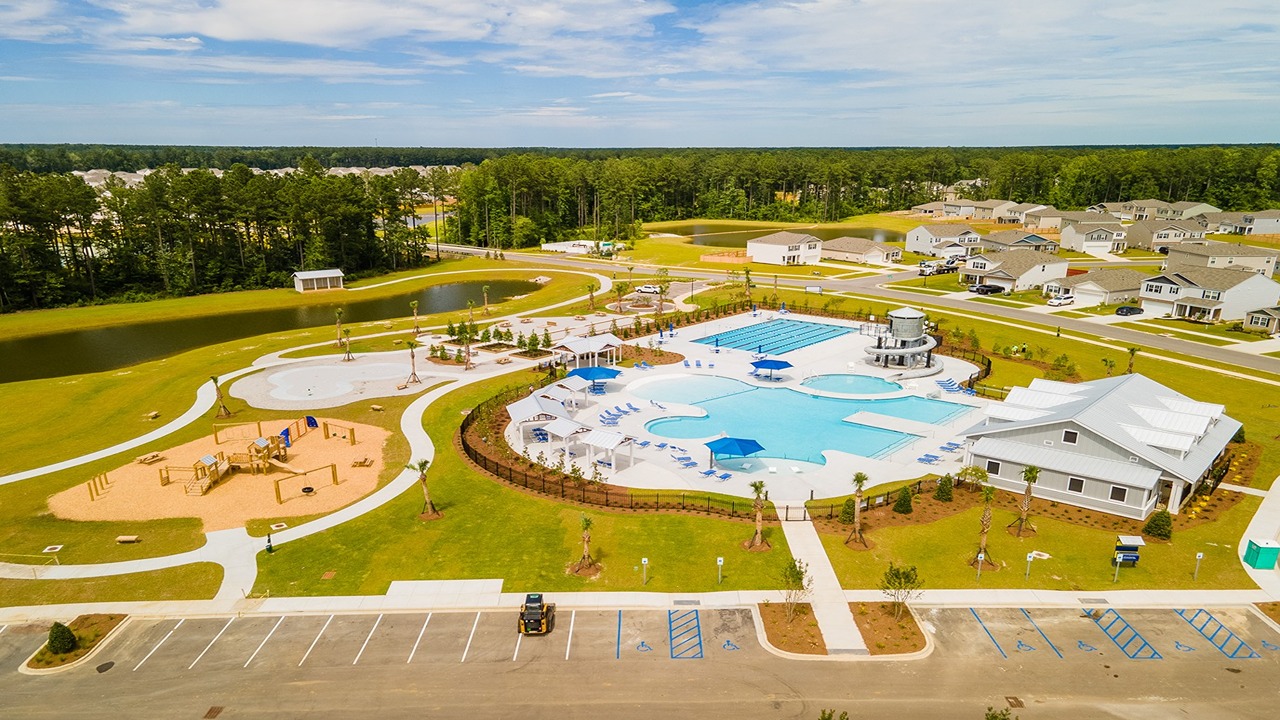 Resort-style pool area in Cane Bay Plantation with large swimming pools, water slide, and lounge seating