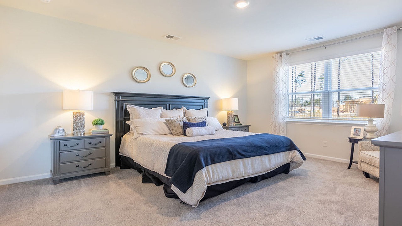 Primary bedroom with soft natural light and neutral tones
