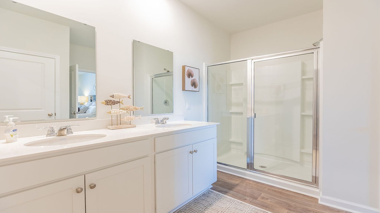 Primary bathroom with dual vanity and walk in shower