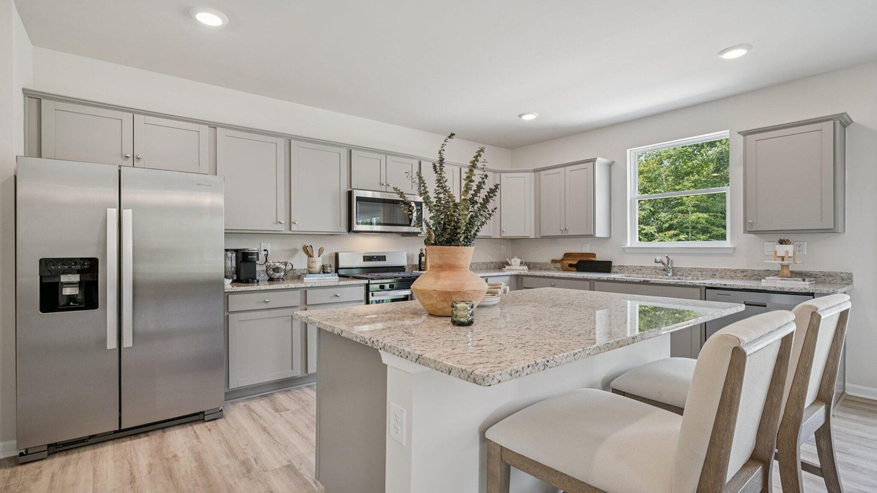 Contemporary kitchen design with white cabinets and polished quartz countertops