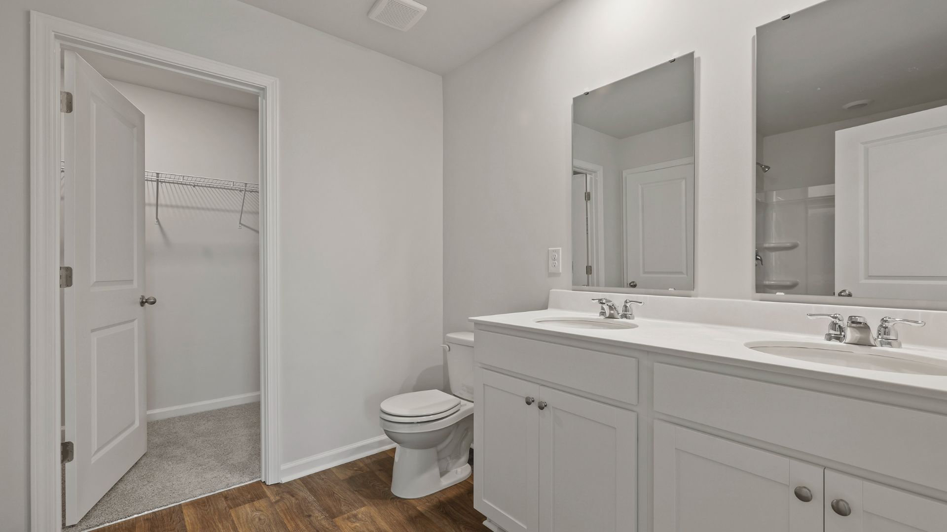 En-suite with double vanity and walk-in closet