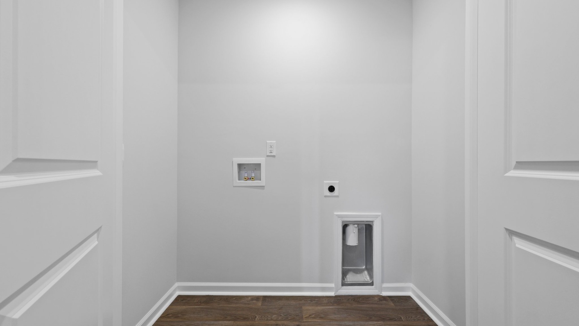 The laundry room is spacious with room to move around and storage.