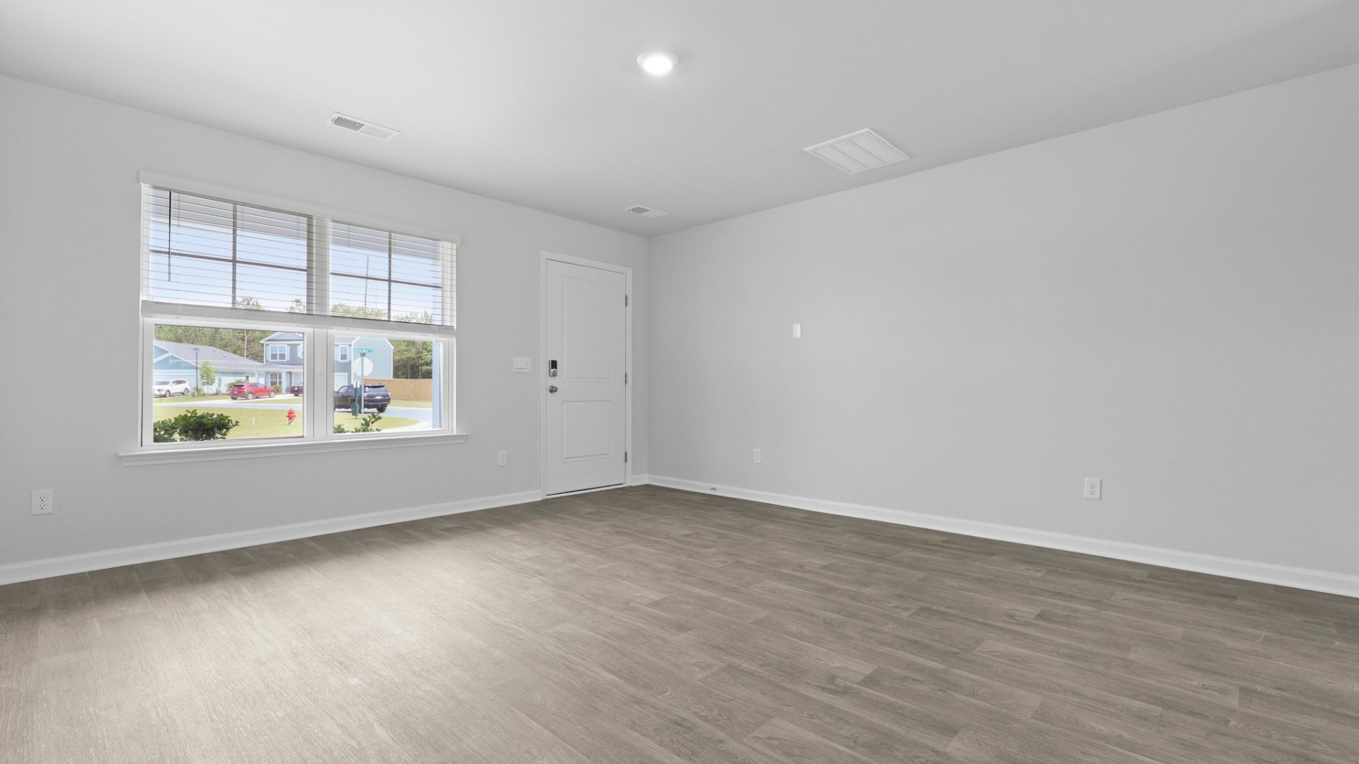 The living room is next to the entrance and is spacious with lots of natural lighting.