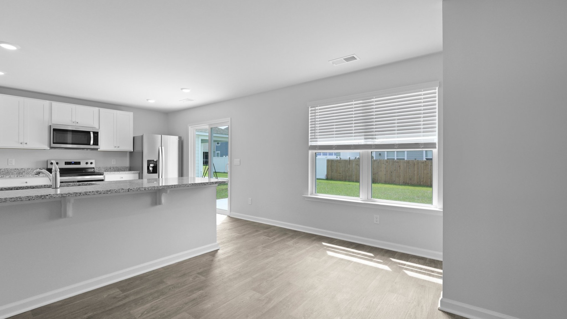 The kitchen features a sliding glass door leading to the backyard.