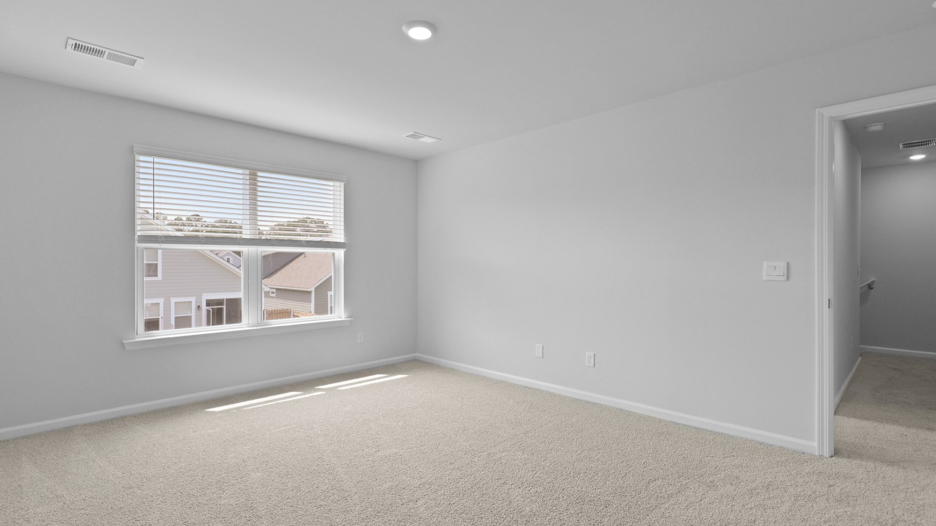 The primary bedroom is spacious and well-lit from double windows.