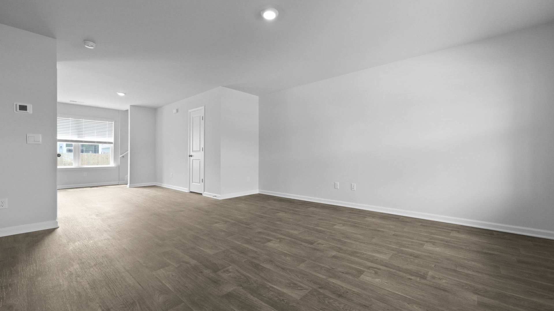 The living room is located next to the kitchen and dining areas.