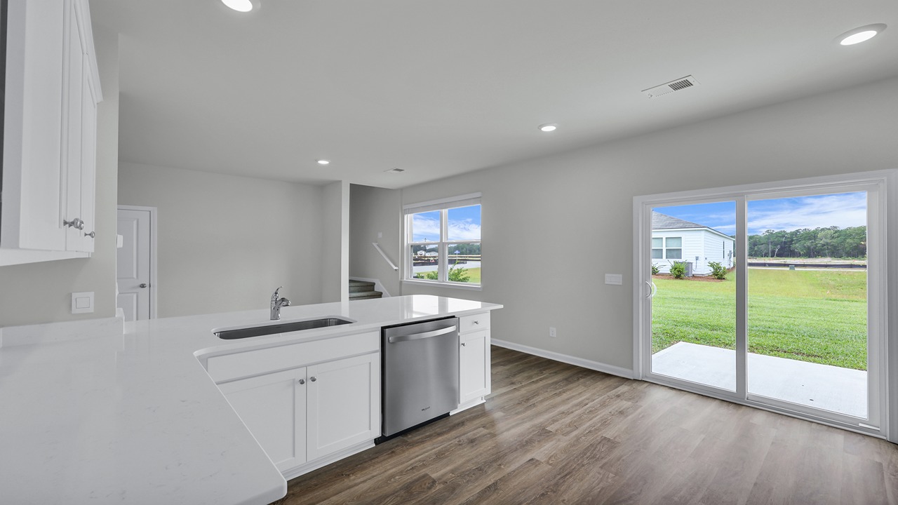 Sliding glass door located in the kitchen leading to the patio and backyard.