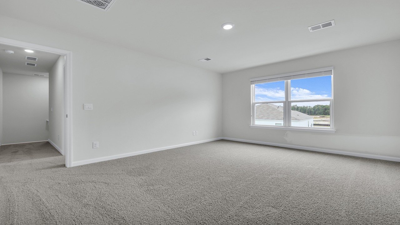 Two windows bring in natural light to the primary bedroom.