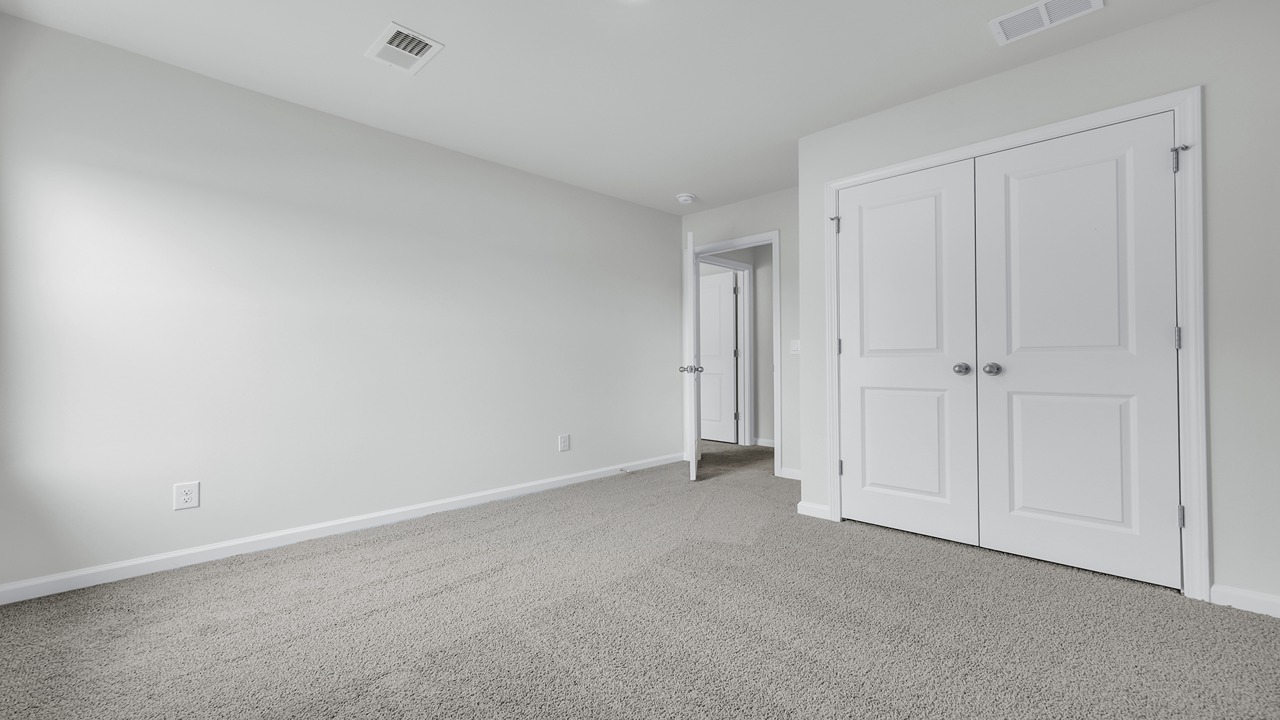 Bedroom 2 is located upstairs with a dual-door closetl