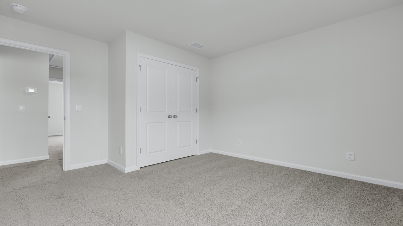 Spacious bedroom 3 with a double door closet.