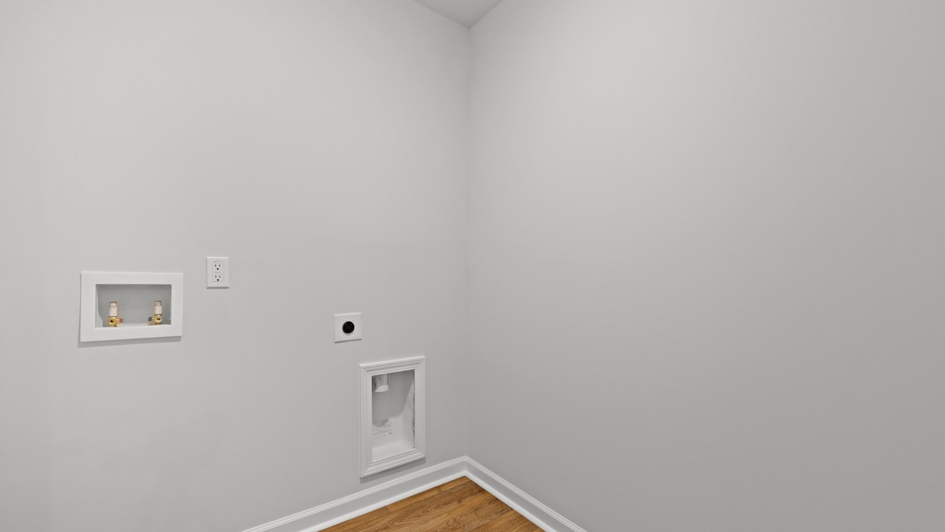 The laundry room in the Sullivan floorplan is located across from the kitchen.