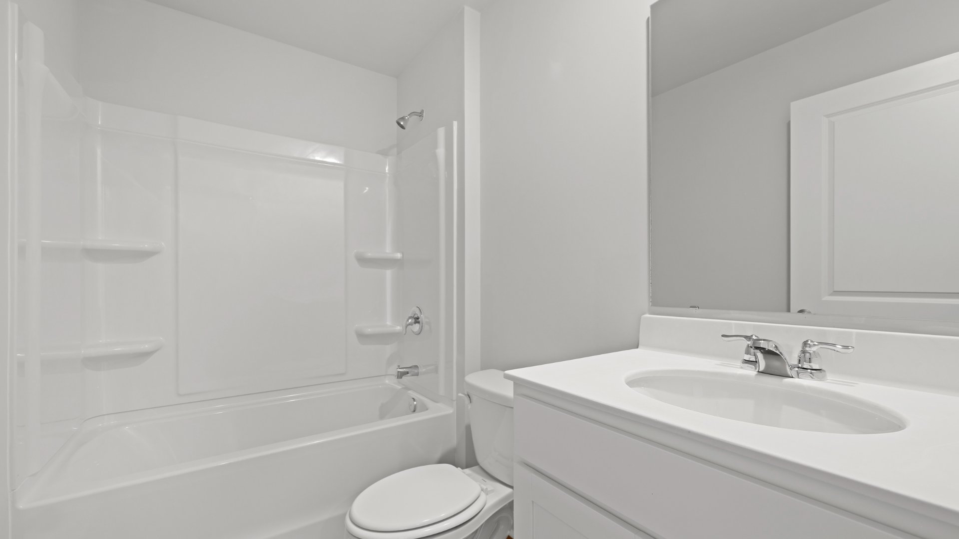 Bathroom 2 features a tub-shower combination with bright quartz countertops.