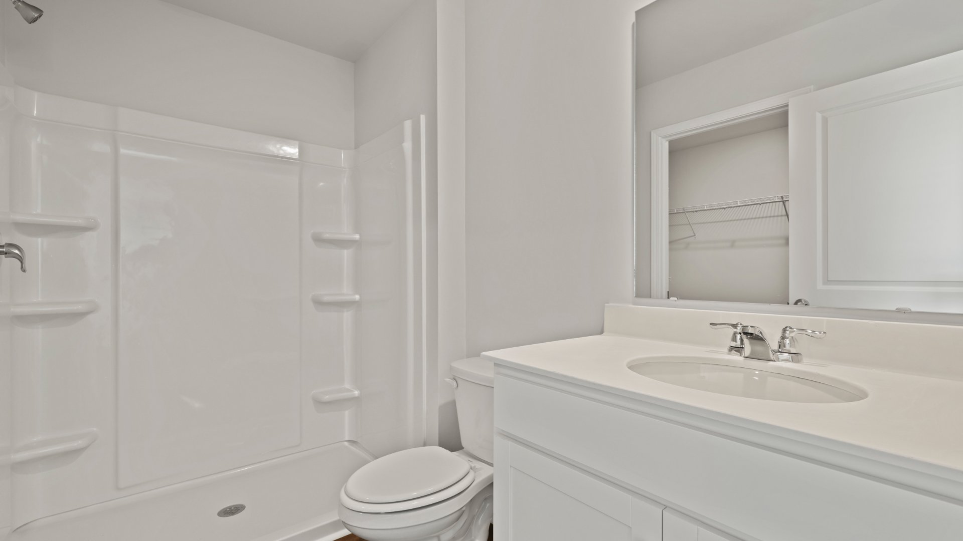 There is a standup walk-in shower in the primary bathroom.