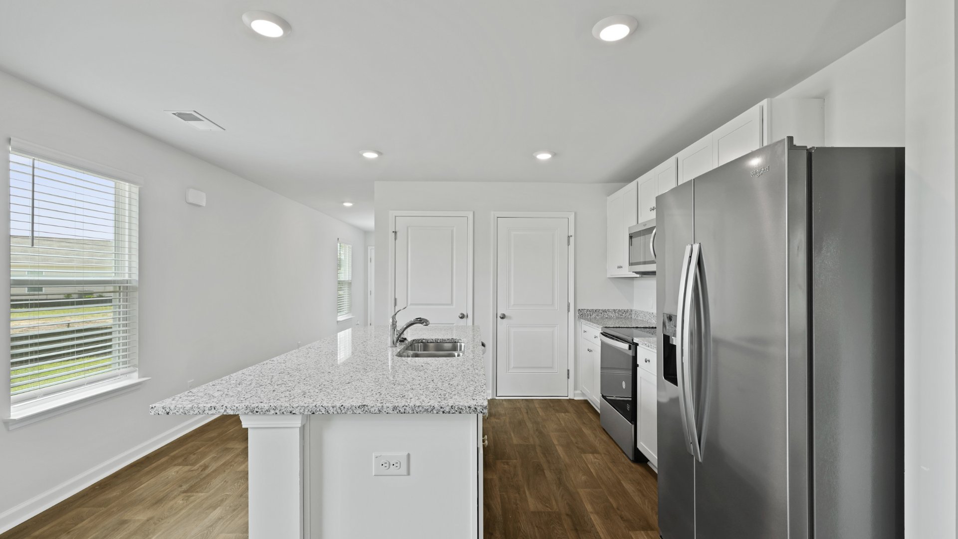 The kitchen in the Downing floorplan has granite countertops.