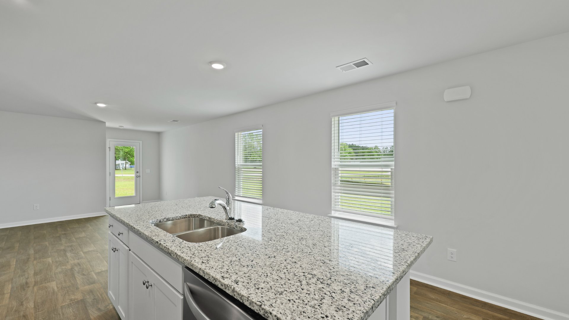 The spacious open-concept living area and kitchen in the Downing floorplan, located in Holly Hill, South Carolina.