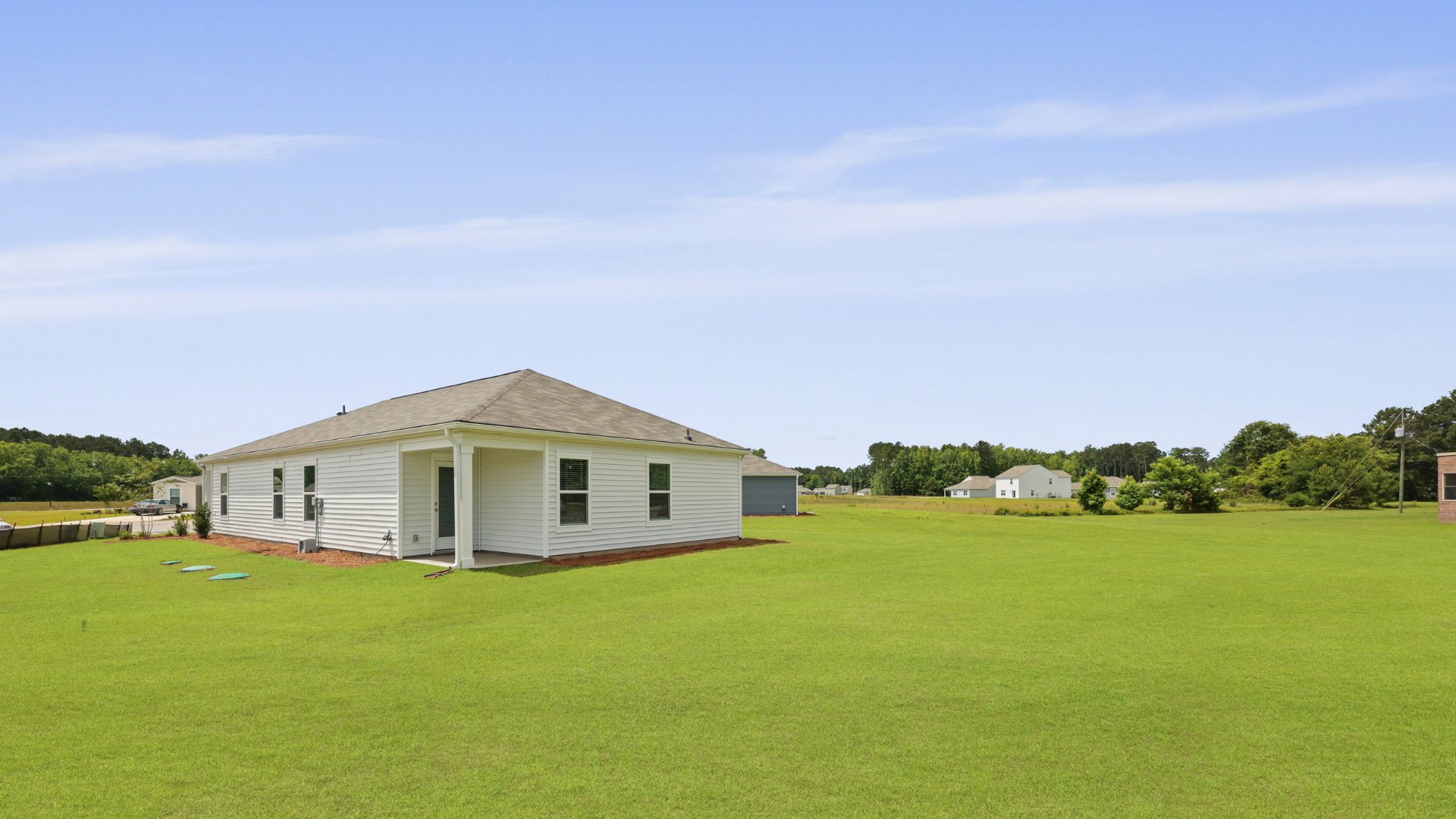 The rear exterior of the Downing floorplan, in Evergreen, located in Holly Hill, South Carolina.