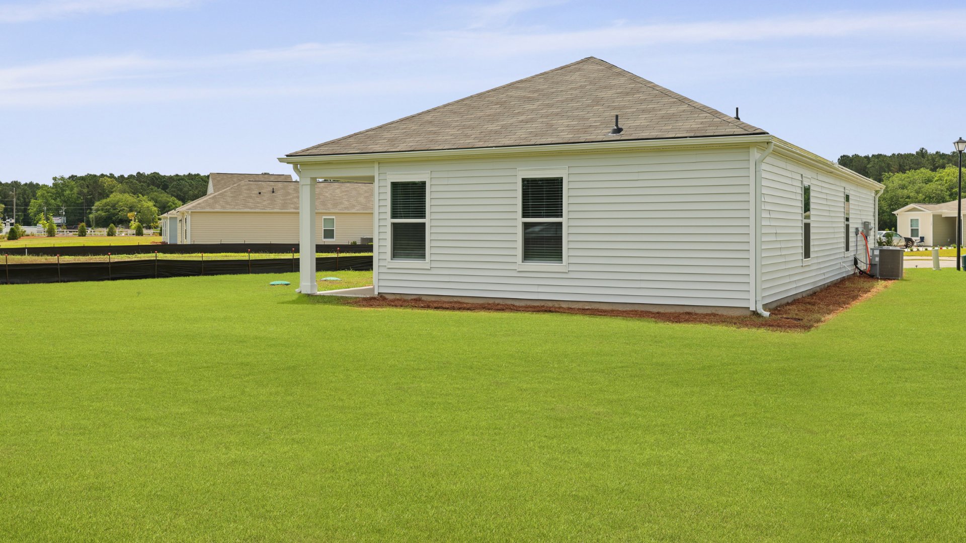 The rear exterior of the Downing floorplan, in Evergreen, located in Holly Hill, South Carolina.