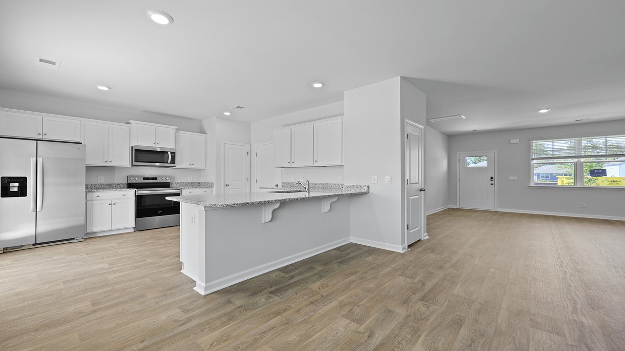 Large kitchen with white cabinets