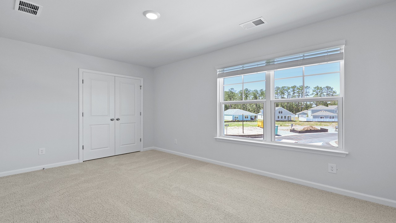 Guest bedroom with large windows