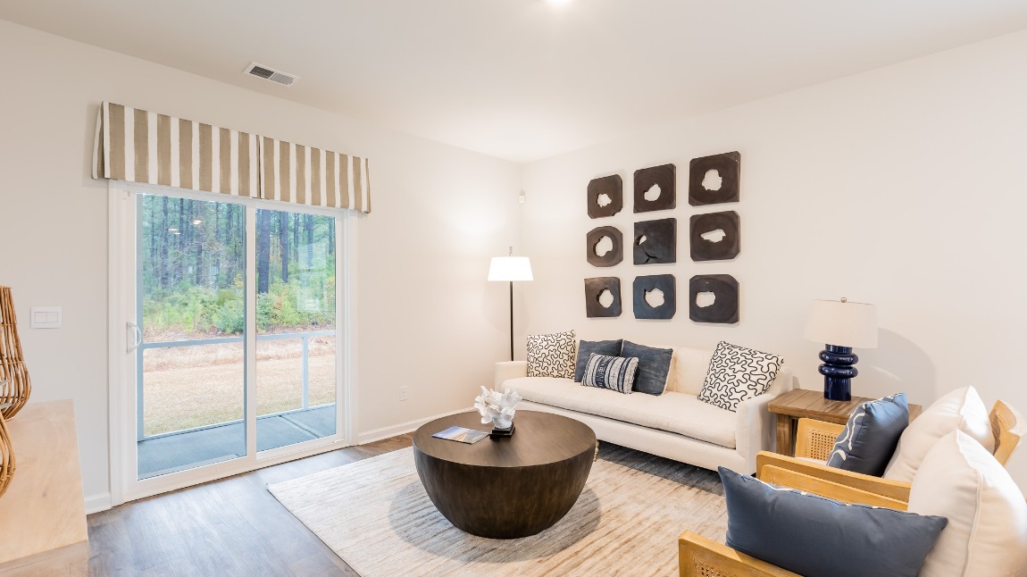 The sliding glass door lets light into the living area.