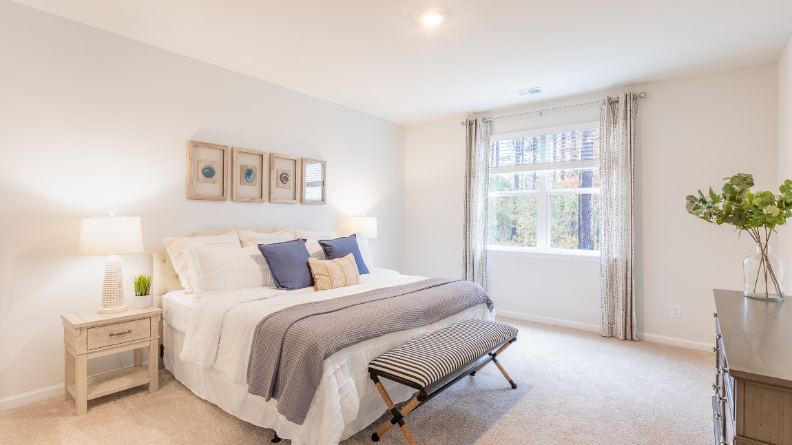 The bright primary bedroom located off of the living room.
