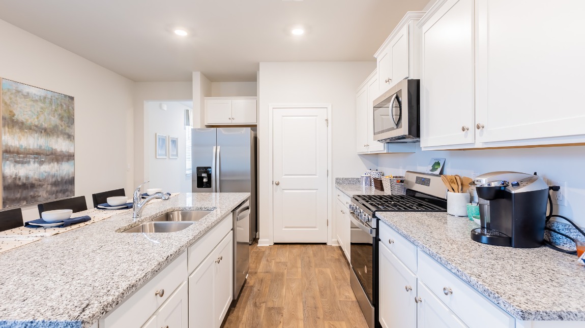 There is ample cabinet and pantry storage in the kitchen.