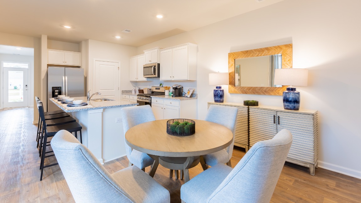 The dining area is located next to the kitchen.