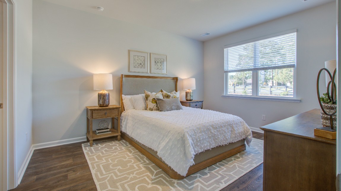 The primary bedroom is located off of the living room for easy access.