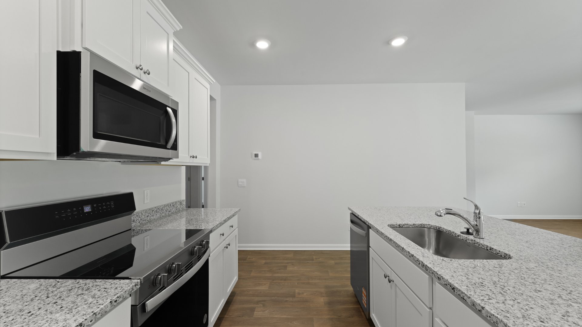 This photo features stainless steel appliances in the kitchen of the Cali floorplan.