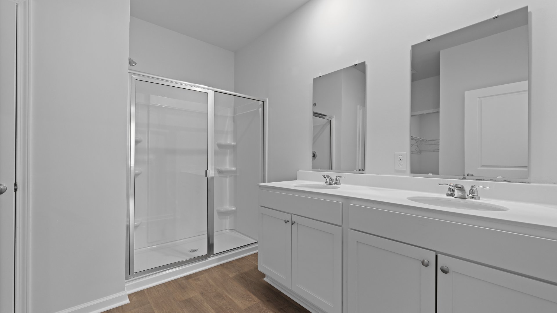 Double vanities and a standup walk-in shower in the primary bathroom.