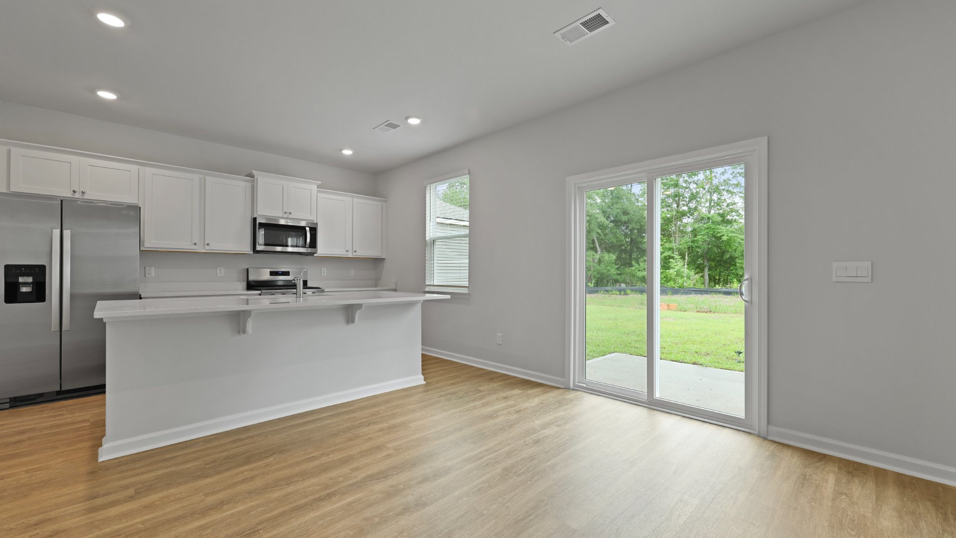 There is a sliding glass door that leads to the patio and backyard in the Bellhaven floorplan.