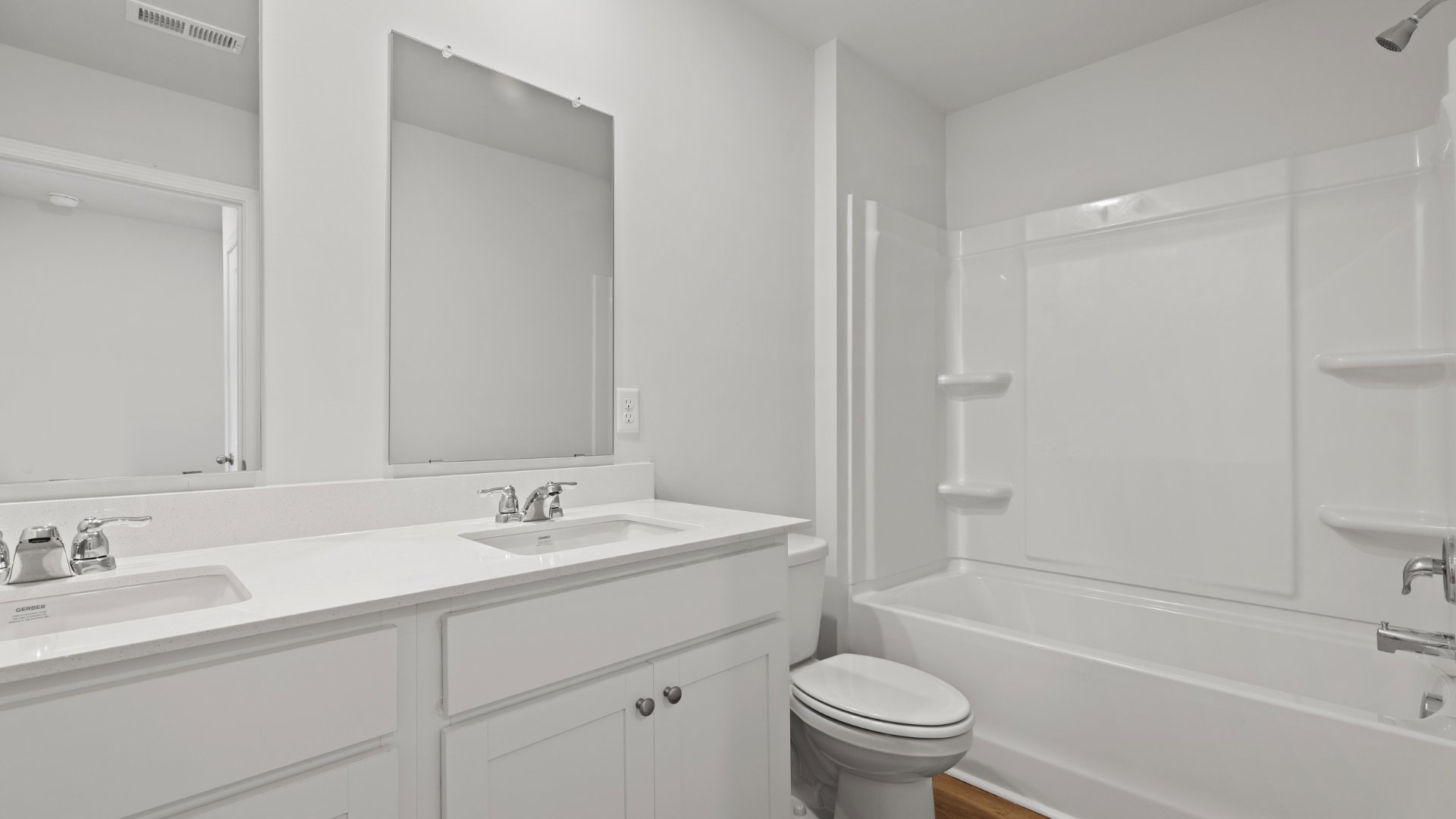 Bathroom 2 is located upstairs with double vanities and a shower-tub combo.