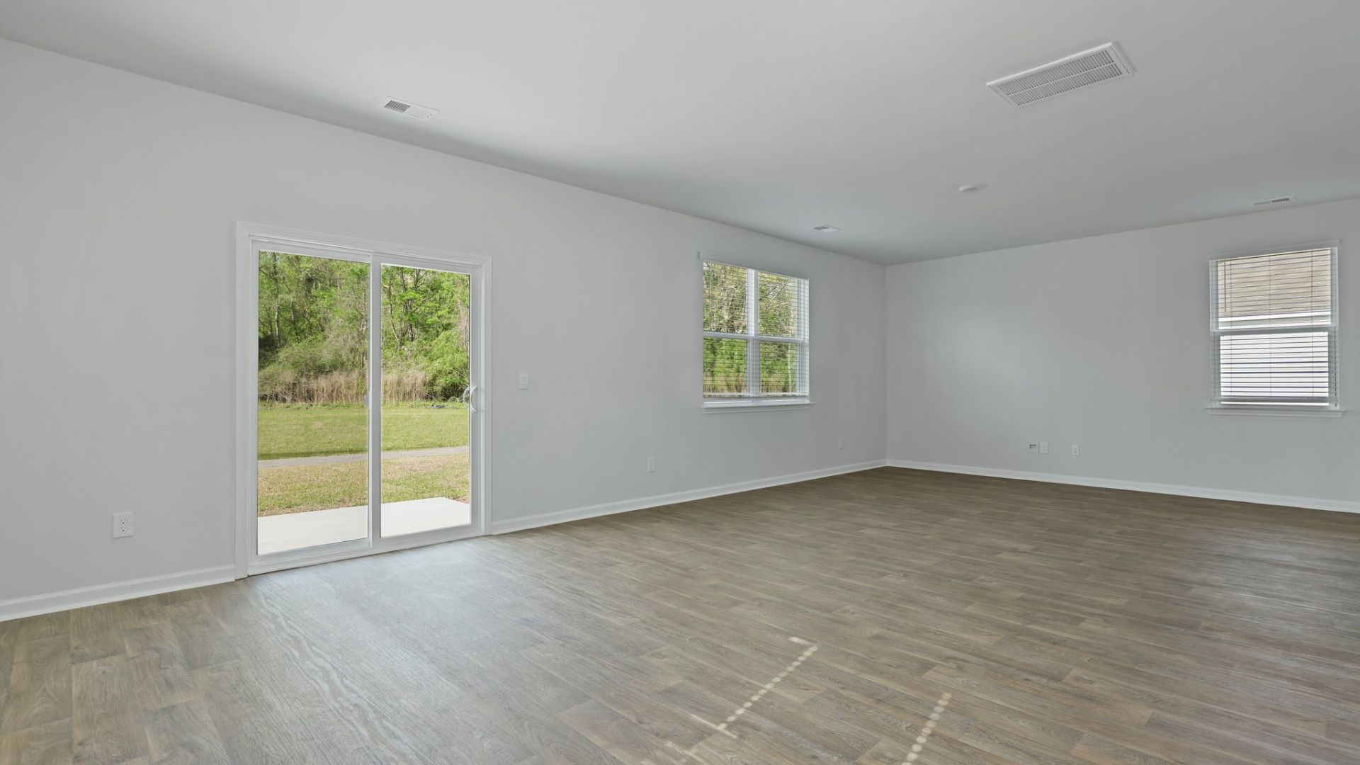 In the great room, there is a sliding glass door that leads to the backyard and patio.