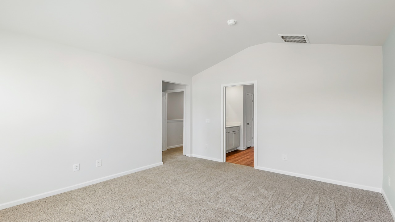 Primary bedroom with cozy carpet