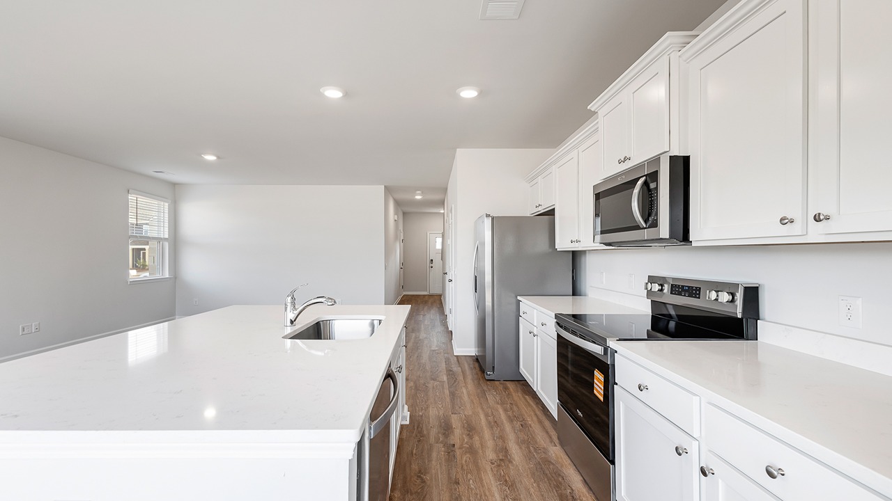 Kitchen with white cabinets and quartz