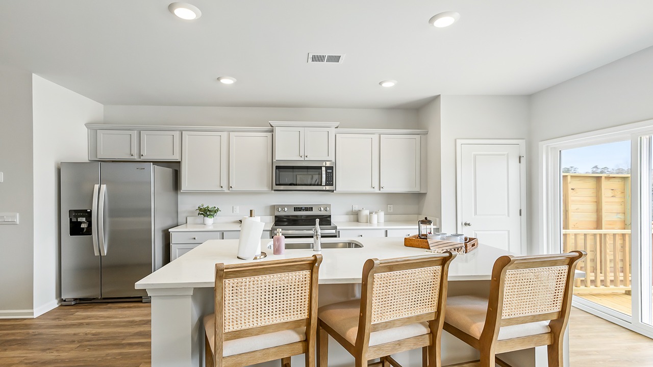 kitchen with white quartz counters and cabinets