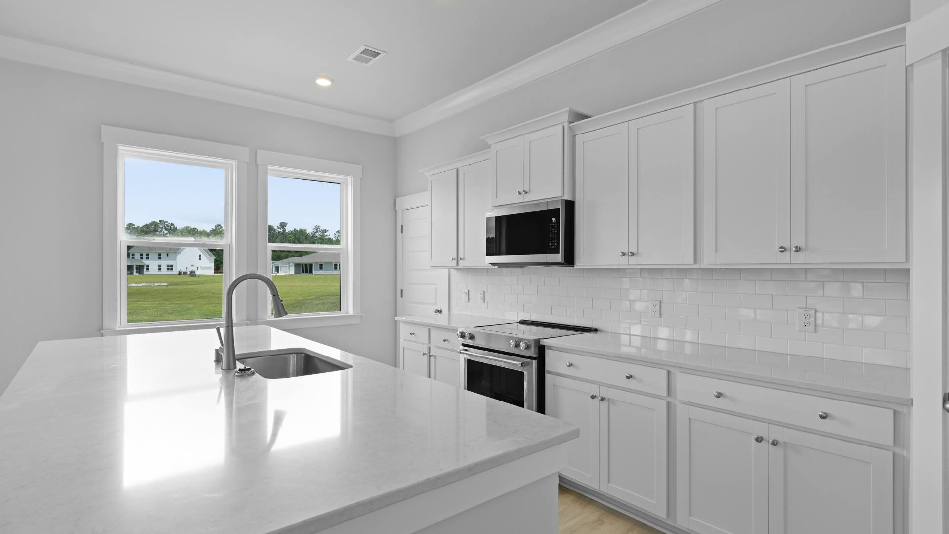 open concept kitchen white cabinets and counter tops