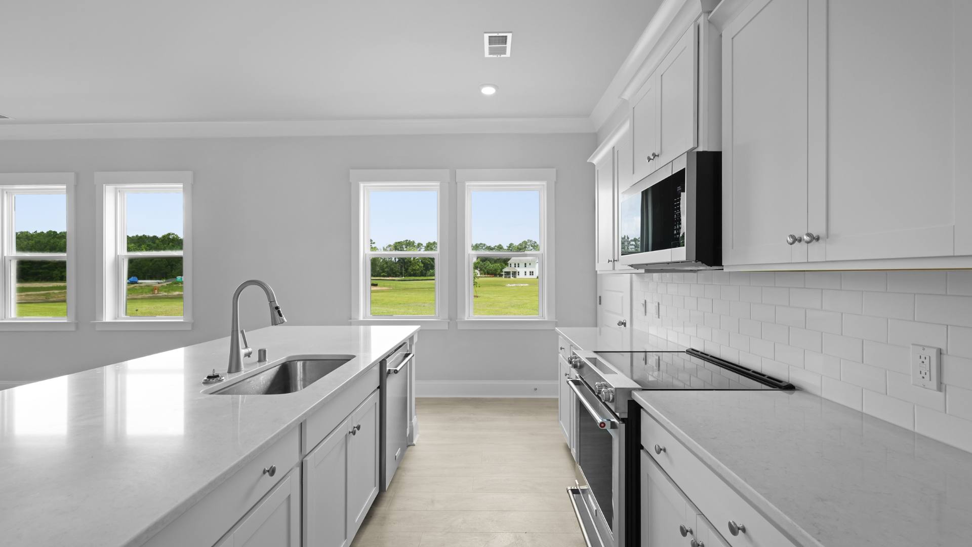 open concept kitchen white cabinets and counter tops