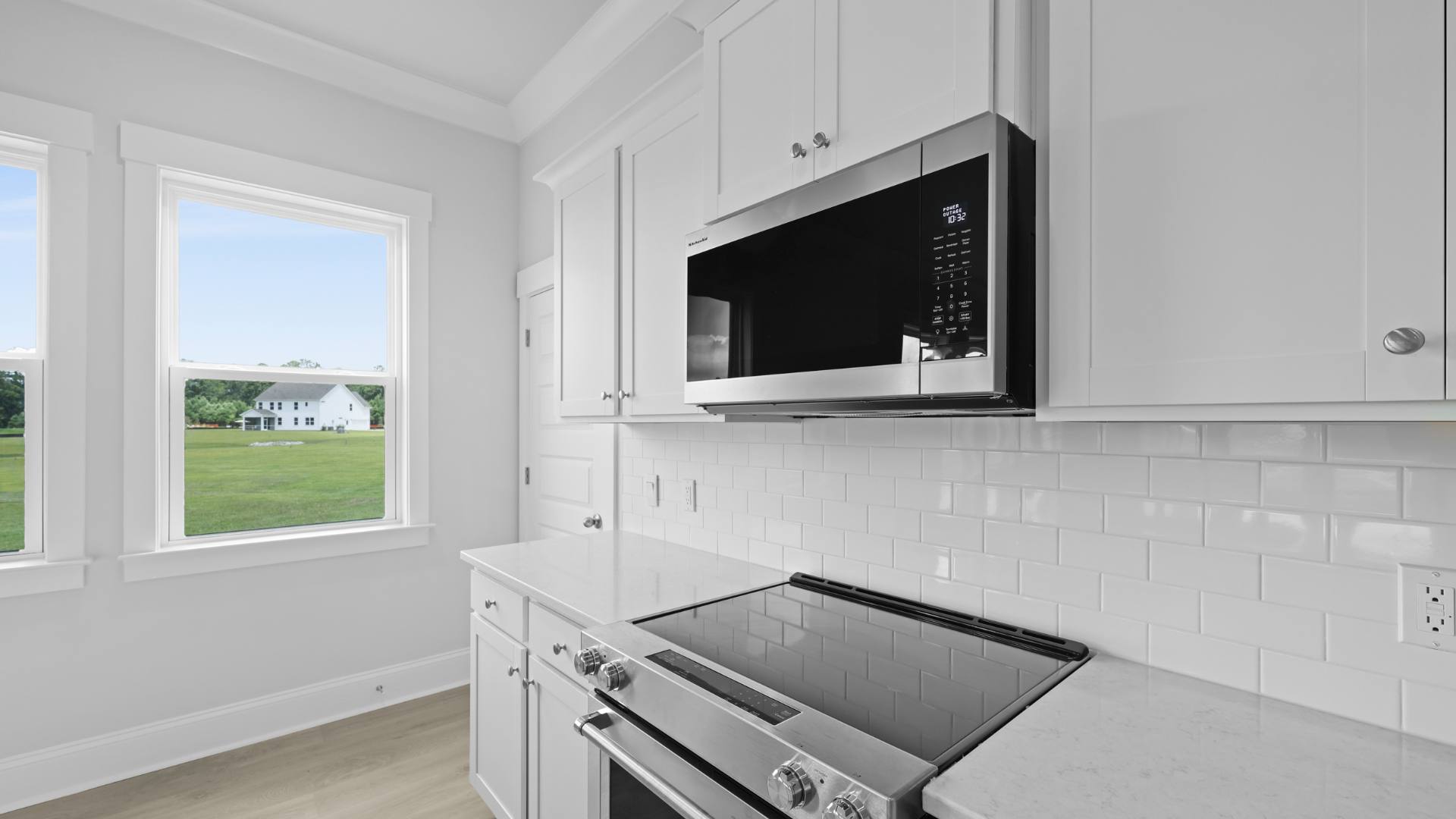 open concept kitchen white cabinets and counter tops