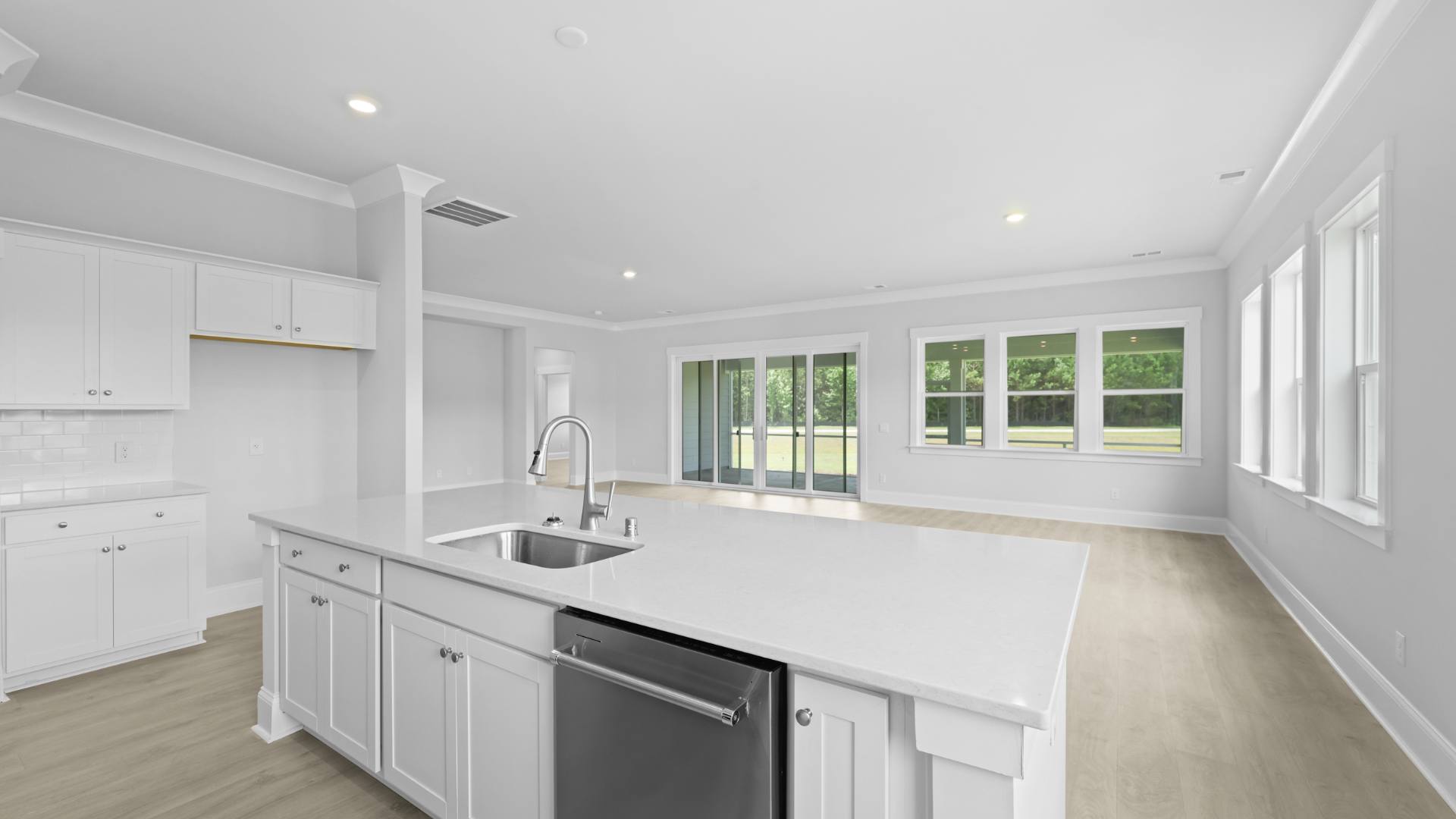 open concept kitchen white cabinets and counter tops