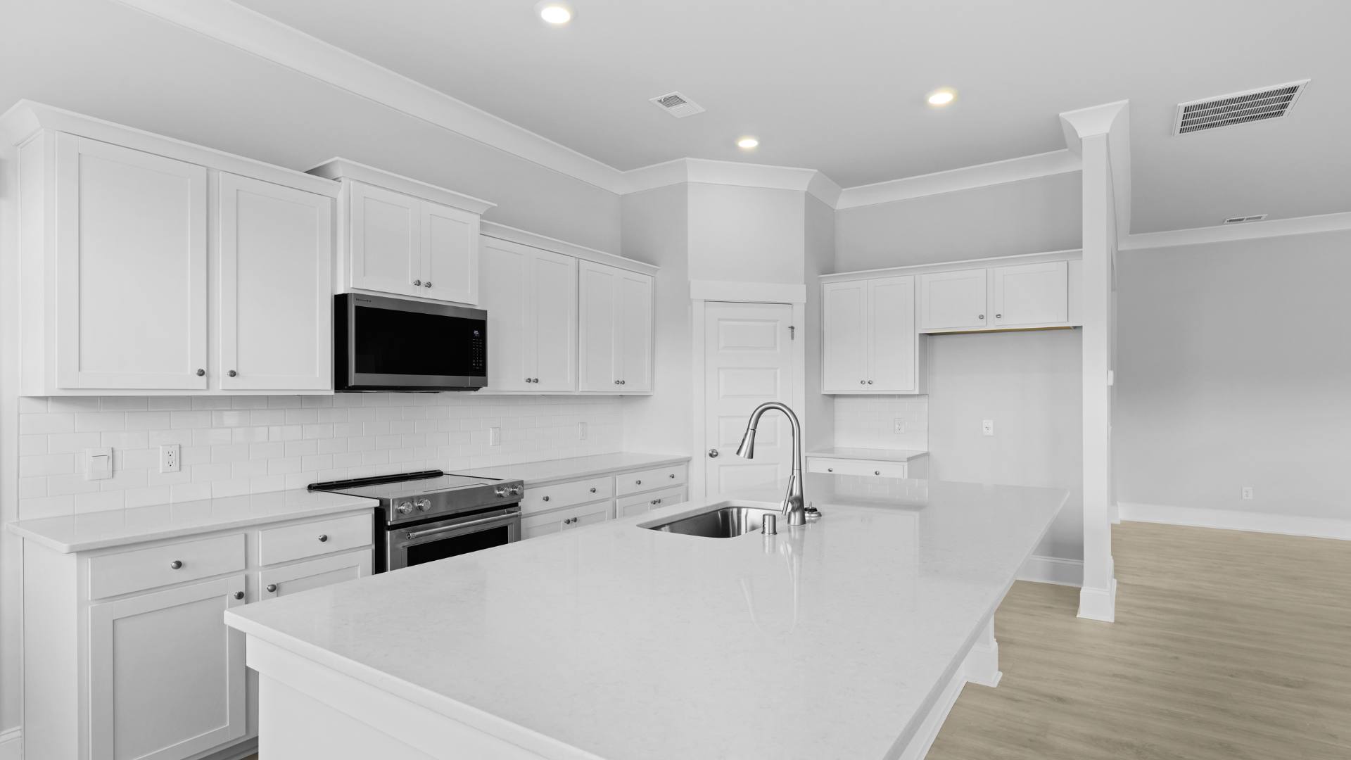 open concept kitchen white cabinets and counter tops