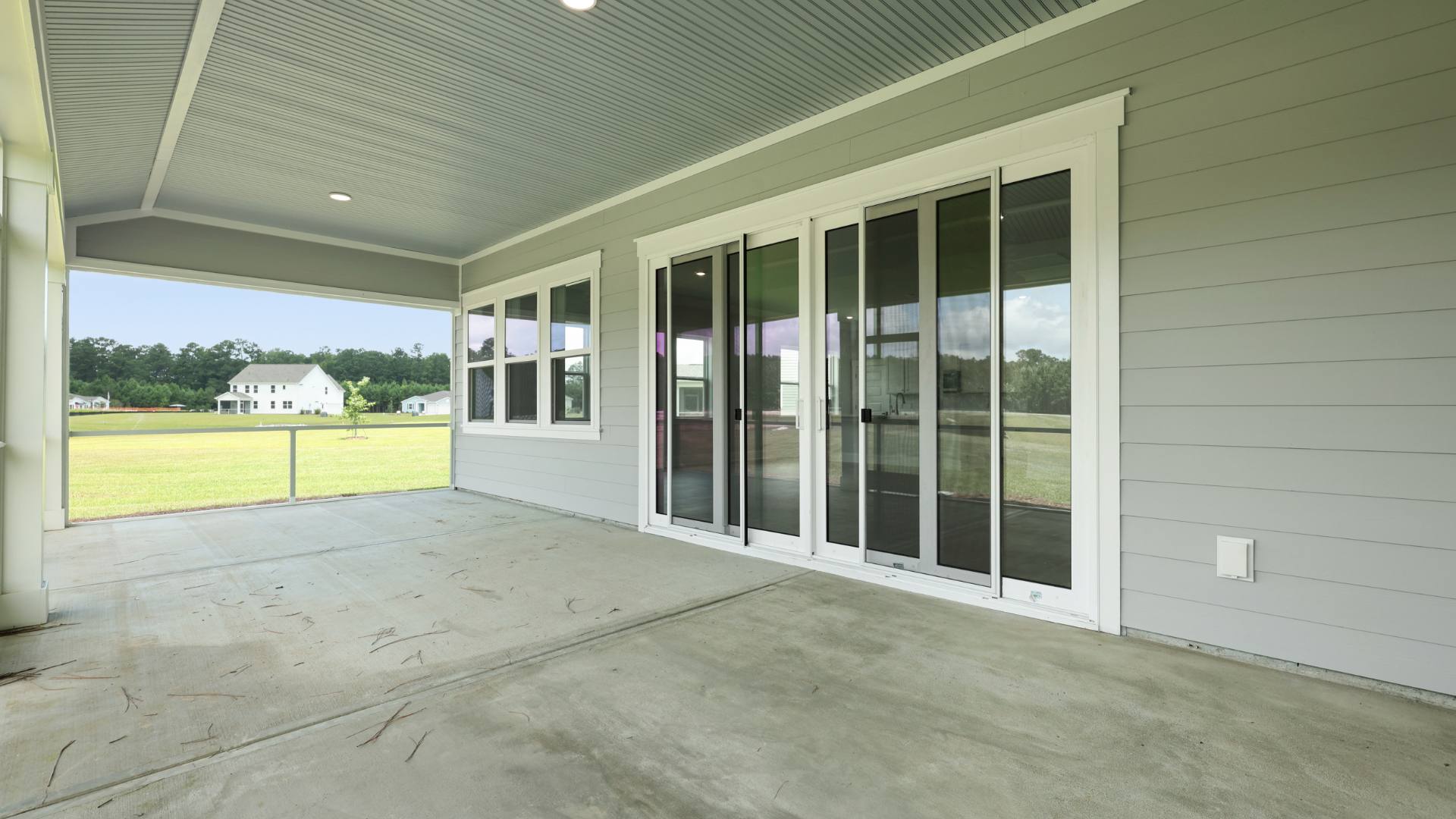 covered large back porch with sliding doors