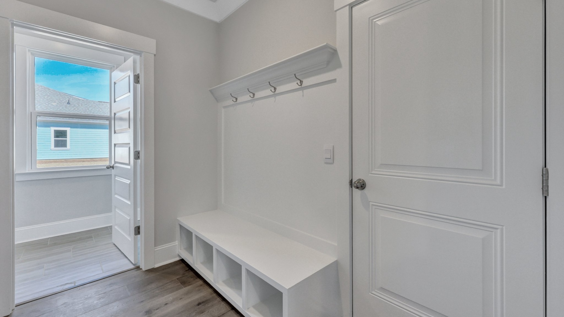 The foyer has a coat rack that offers extra storage for shoes and coats.