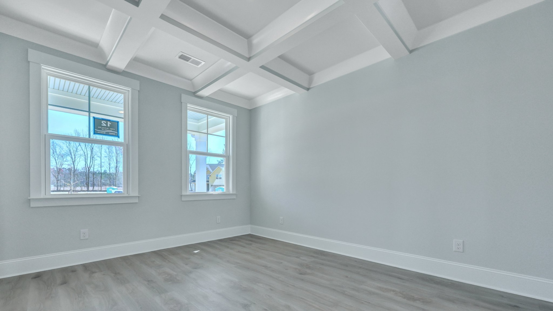 The dining room has natural lighting from the two windows.