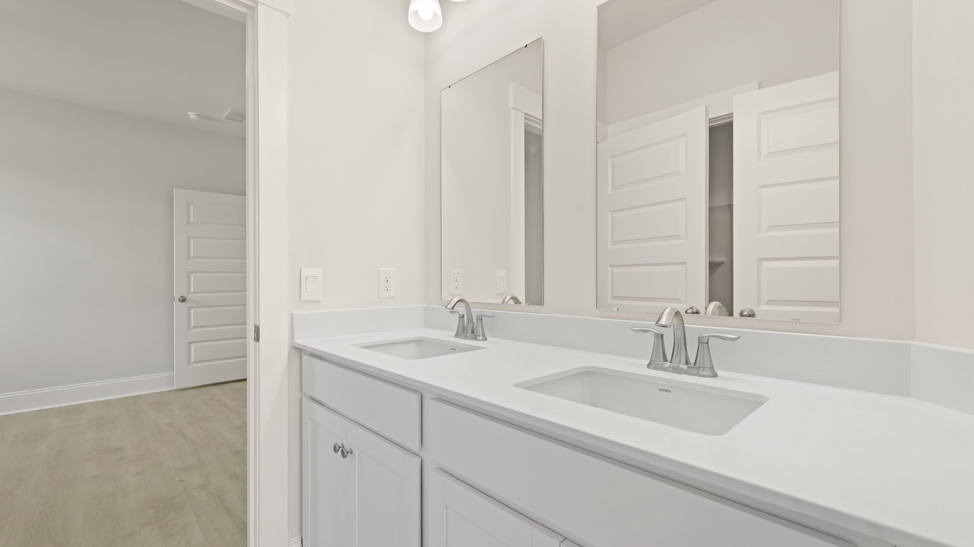 There are double vanities in bathroom 2 offering counterspace and storage in the cabinets underneath.