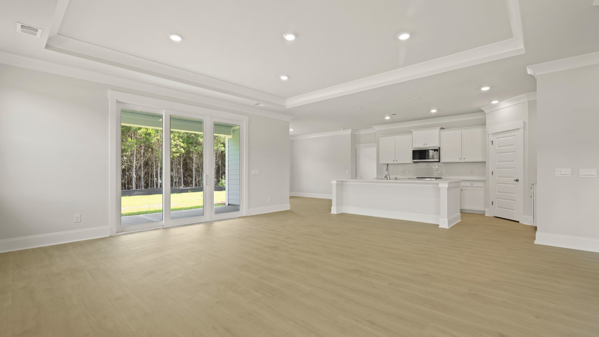 The triple sliding glass doors allow for natural light to enter the living area as well as the dining area.