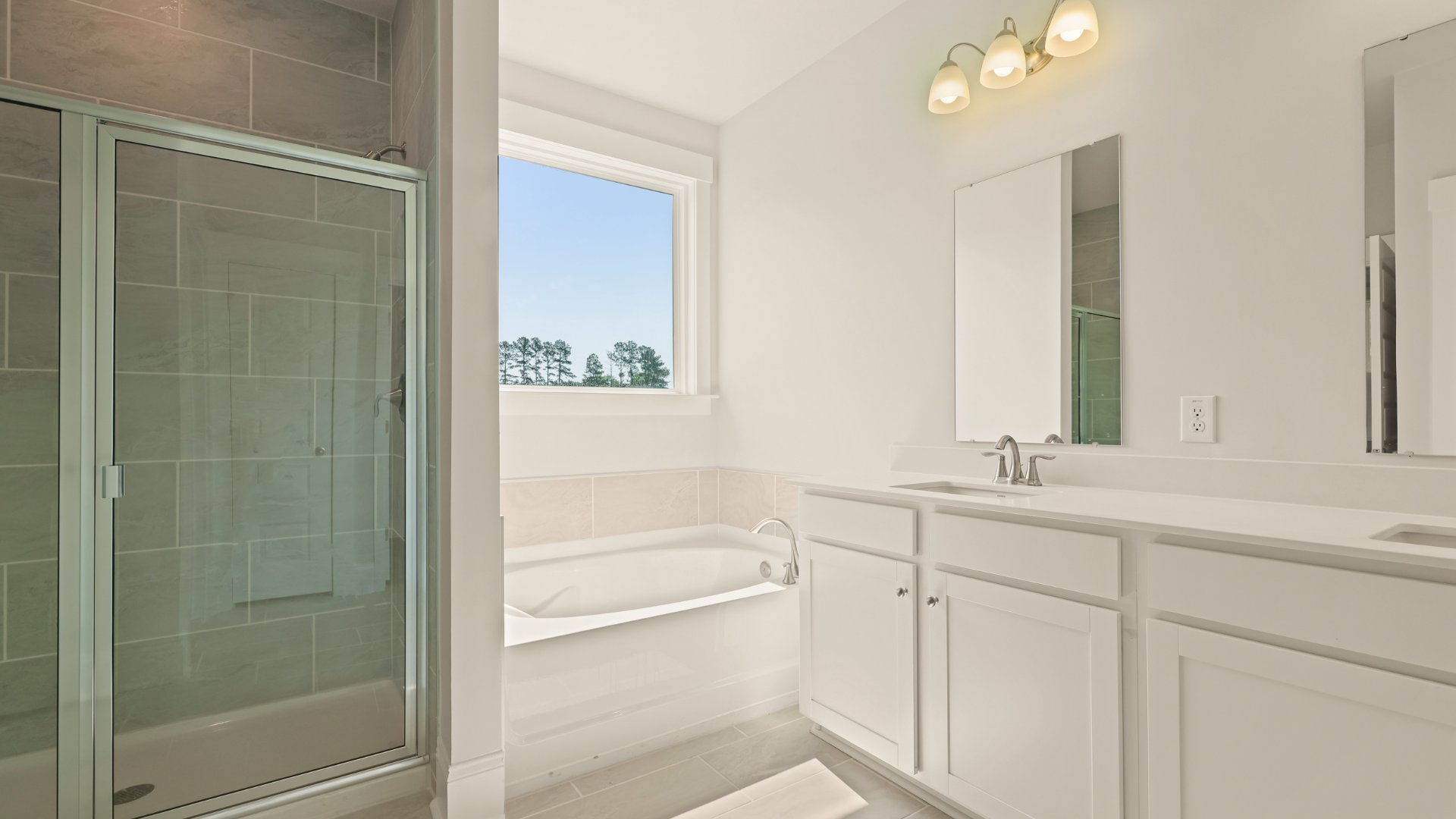 There is a tub and stand-up shower located in the primary bathroom.