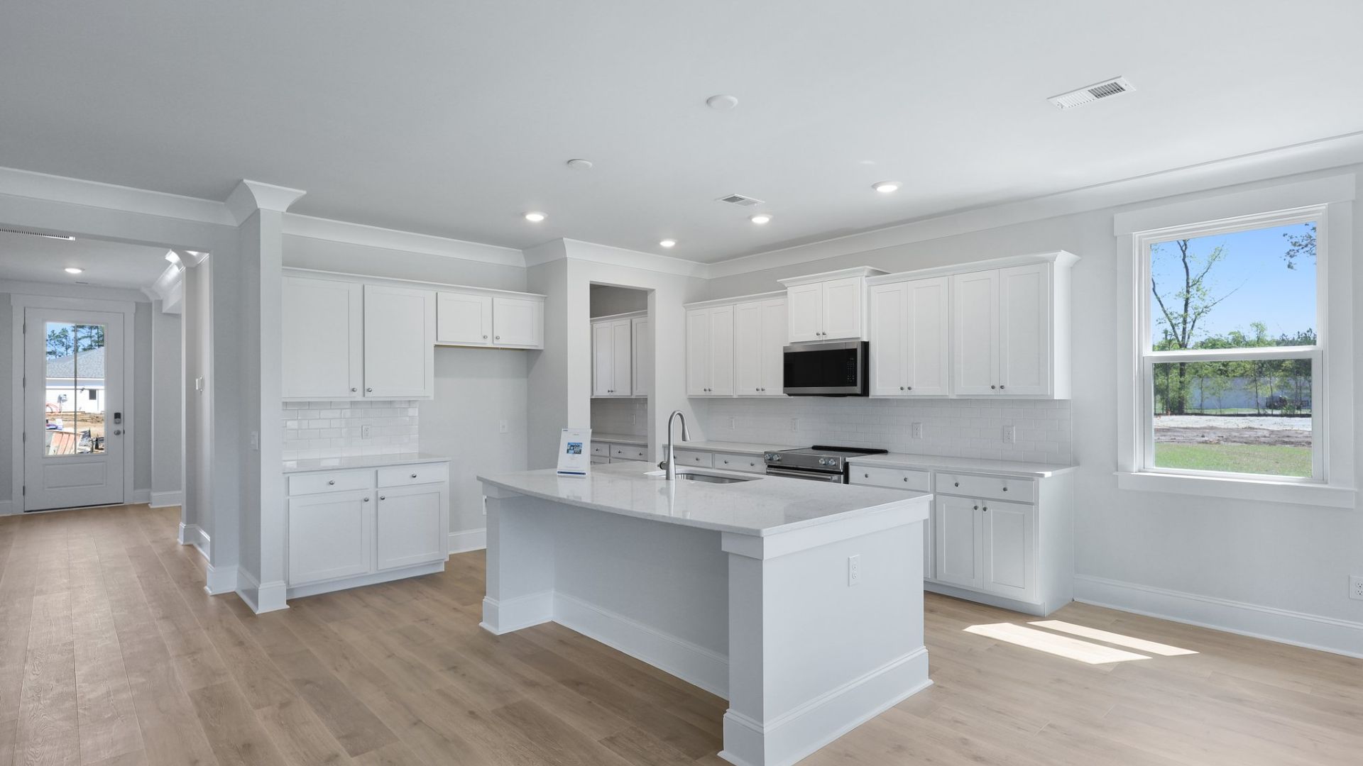 The kitchen has quartz countertops and a backsplash.