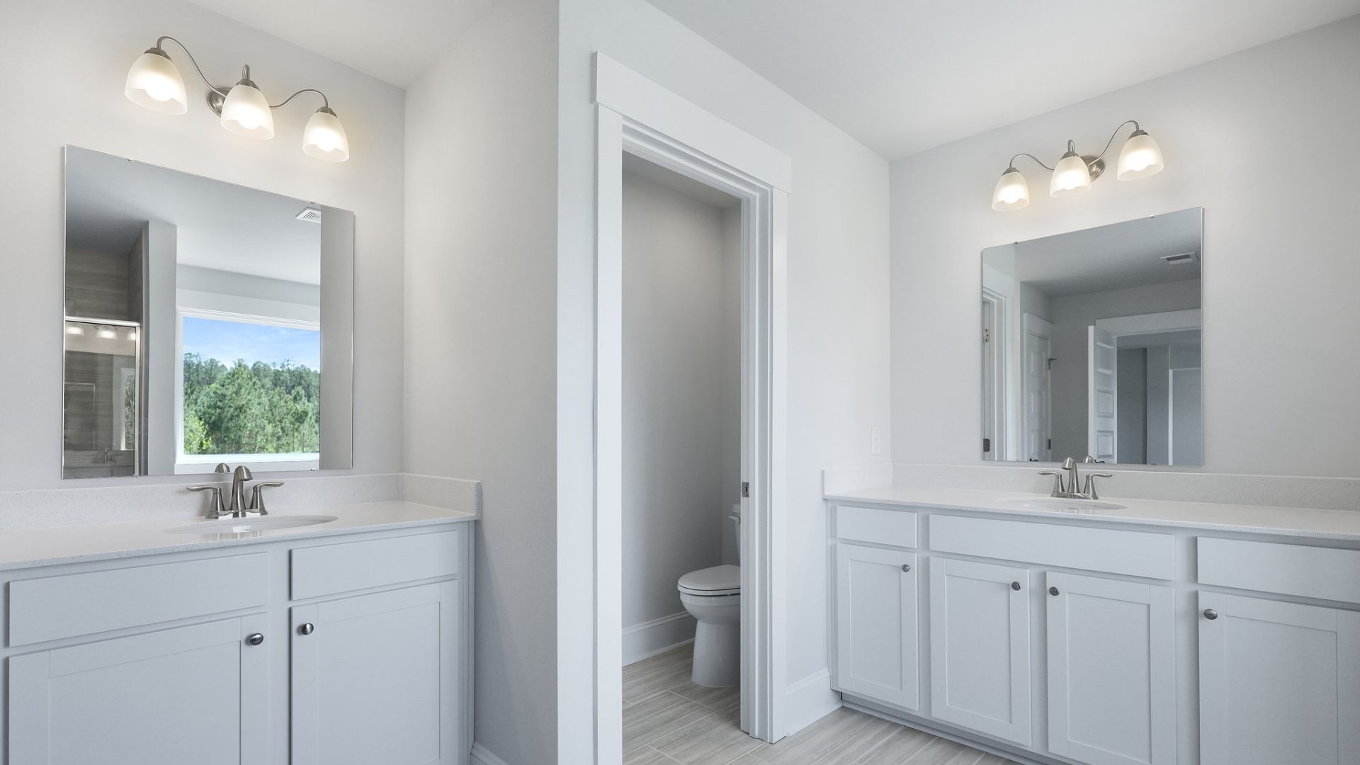 The primary bathroom has two sinks that are separated with plenty of space to move around.
